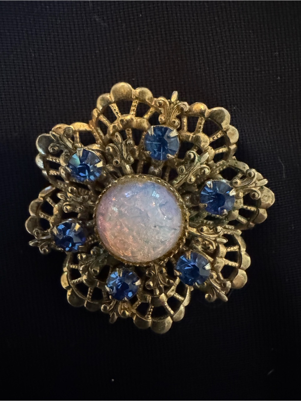 Gold-Tone Floral Brooch with Blue Crystal Accents and Iridescent Center